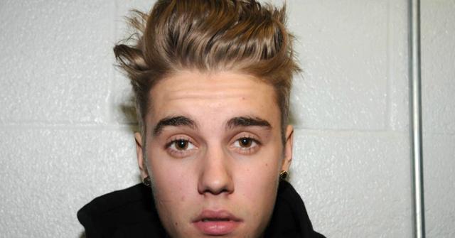 In this handout photo provided by Miami-Dade Police Department, pop star Justin Bieber poses for a booking photo at the Miami-Dade Police Department on January 23, 2014 in Miami, Florida. Justin Bieber was charged with drunken driving, resisting arrest and driving without a valid license after Miami Beach Police found the pop star street racing on Thursday morning.