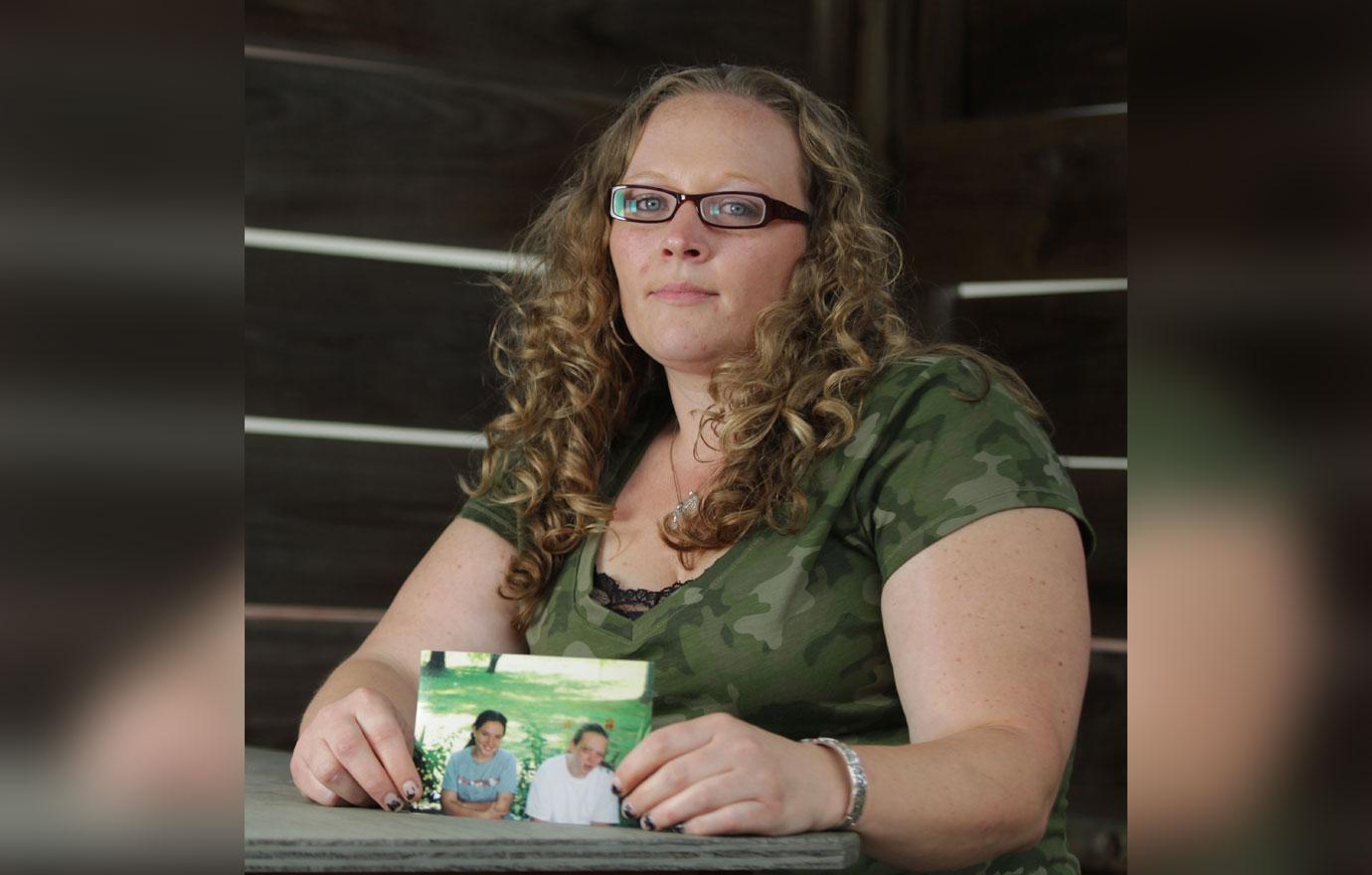 Tasha Lee Wearing Glasses, Green Camoflage T-Shirt Holding Photo