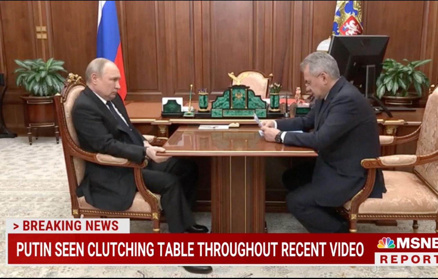 stone faced putin tightly grips table during kremlin meeting with the general as ailing health rumors swirl