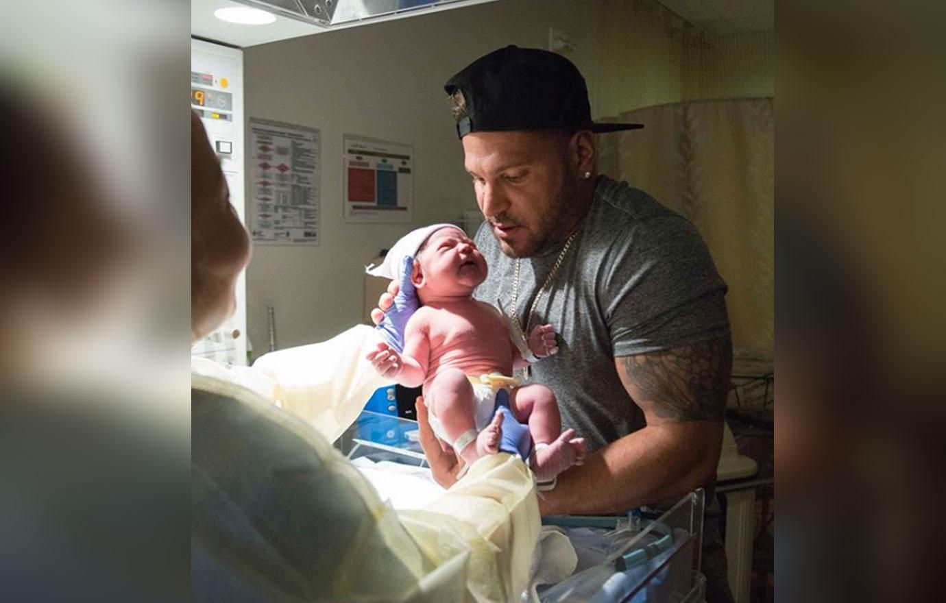 Ronnie Magro Ortiz holding his newborn baby.