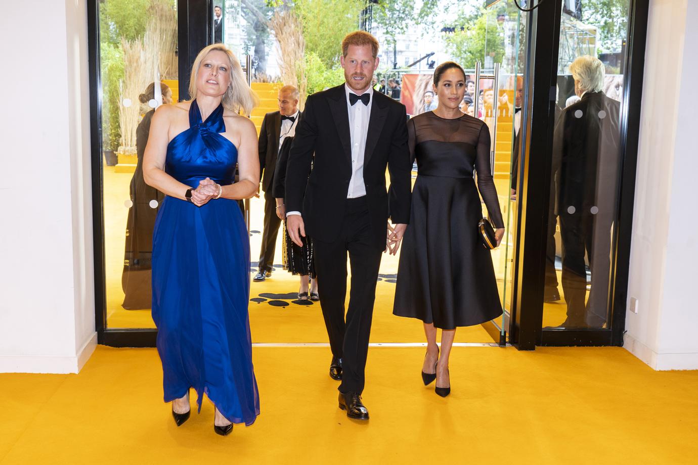 Prince Harry, Duke of Sussex (C) and Meghan, Duchess of Sussex (R) arrive to attend the European Premiere of Disney's "The Lion King" at Odeon Luxe Leicester Square on July 14, 2019 in London, England.