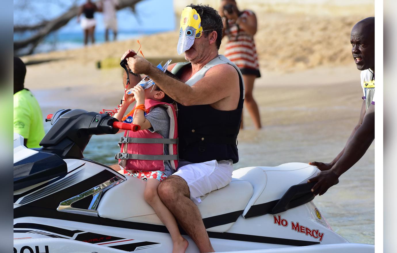 //simon cowell wears transformers mask on jet ski ride with son