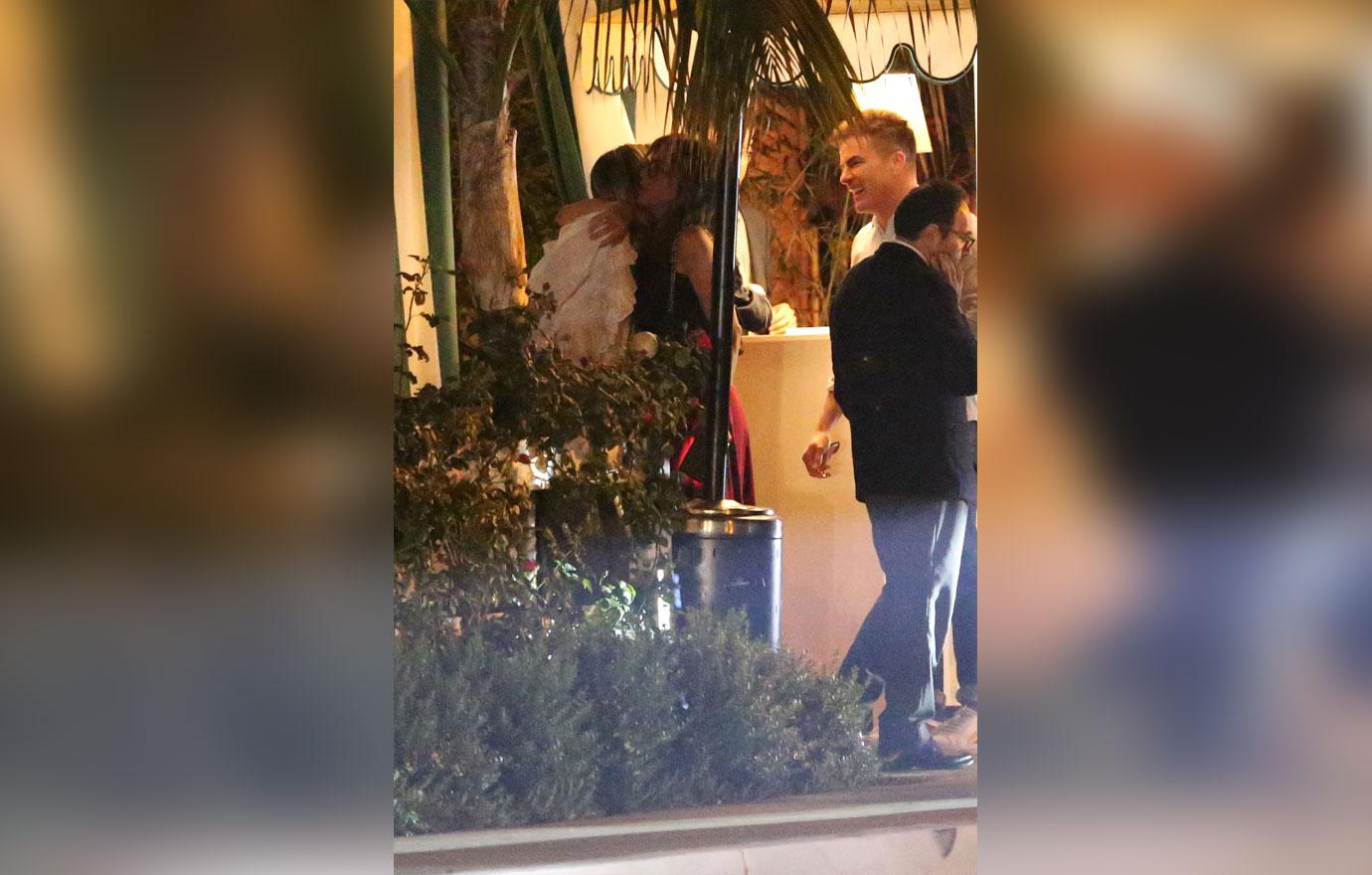 Jennifer Aniston kisses a male friend goodbye after having dinner in Los Angeles. The 50 year old actress is wearing a red skirt with a black top. She dined at the restaurant with a few friends including a mystery man who she gave a hug and a kiss to on the cheek before departing.