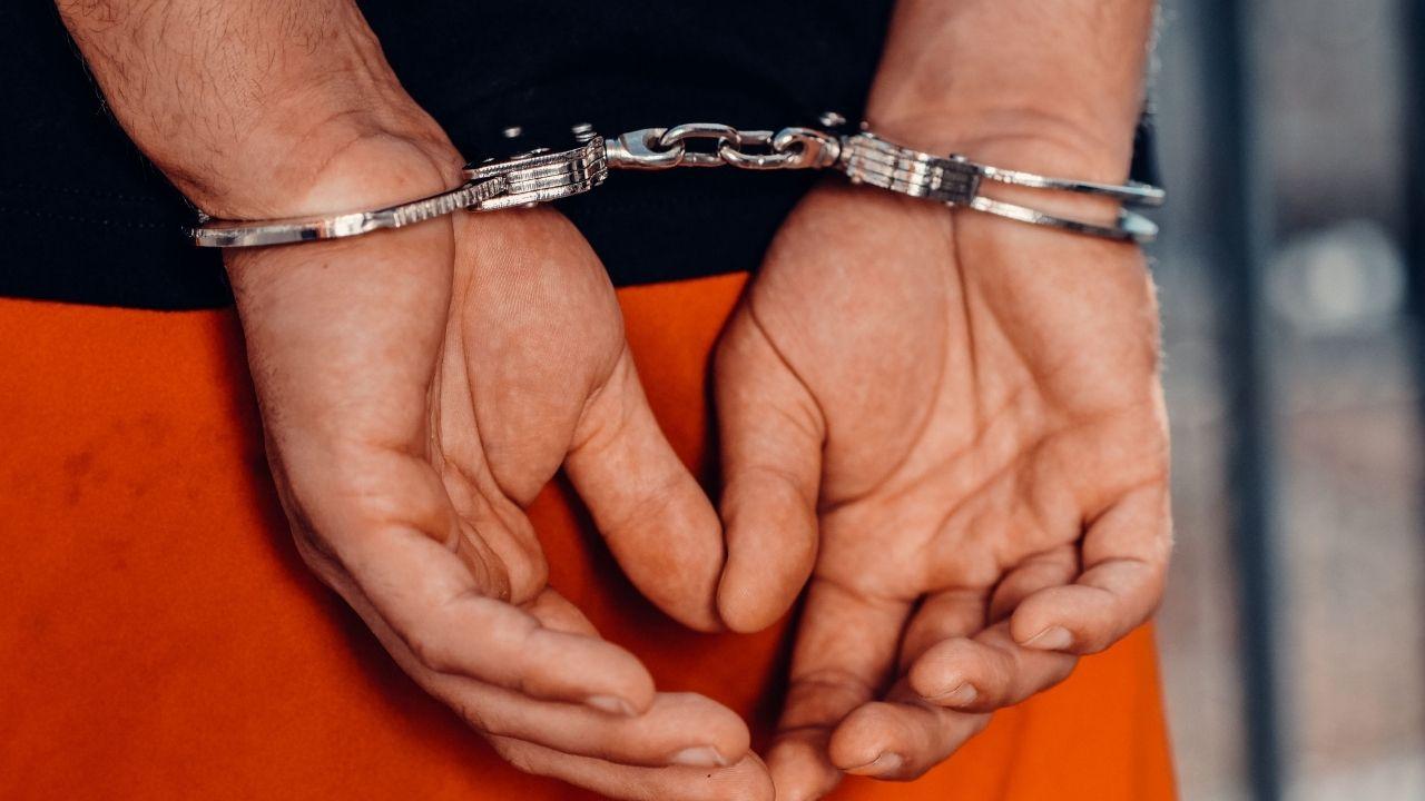Photo of a man in hand cuffs