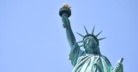 //woman climbs on statue of liberty in ice protest pp