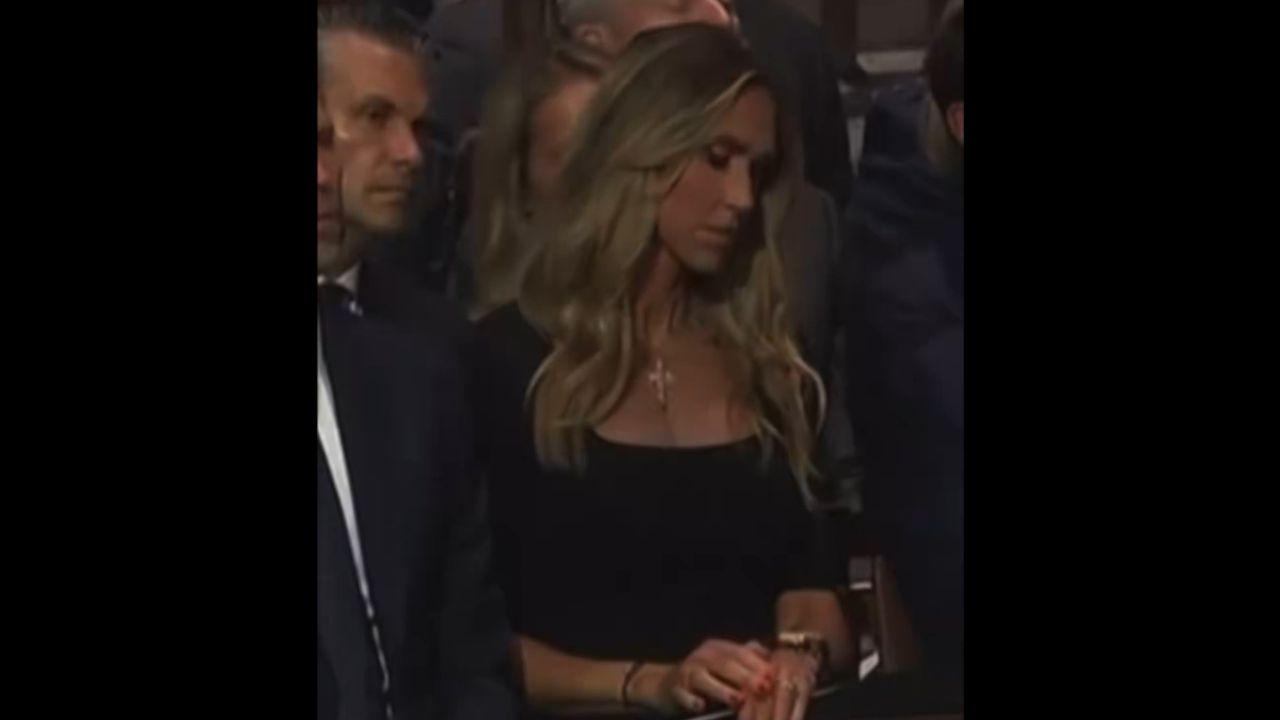 A camera caught Lara checking her watch during the service.