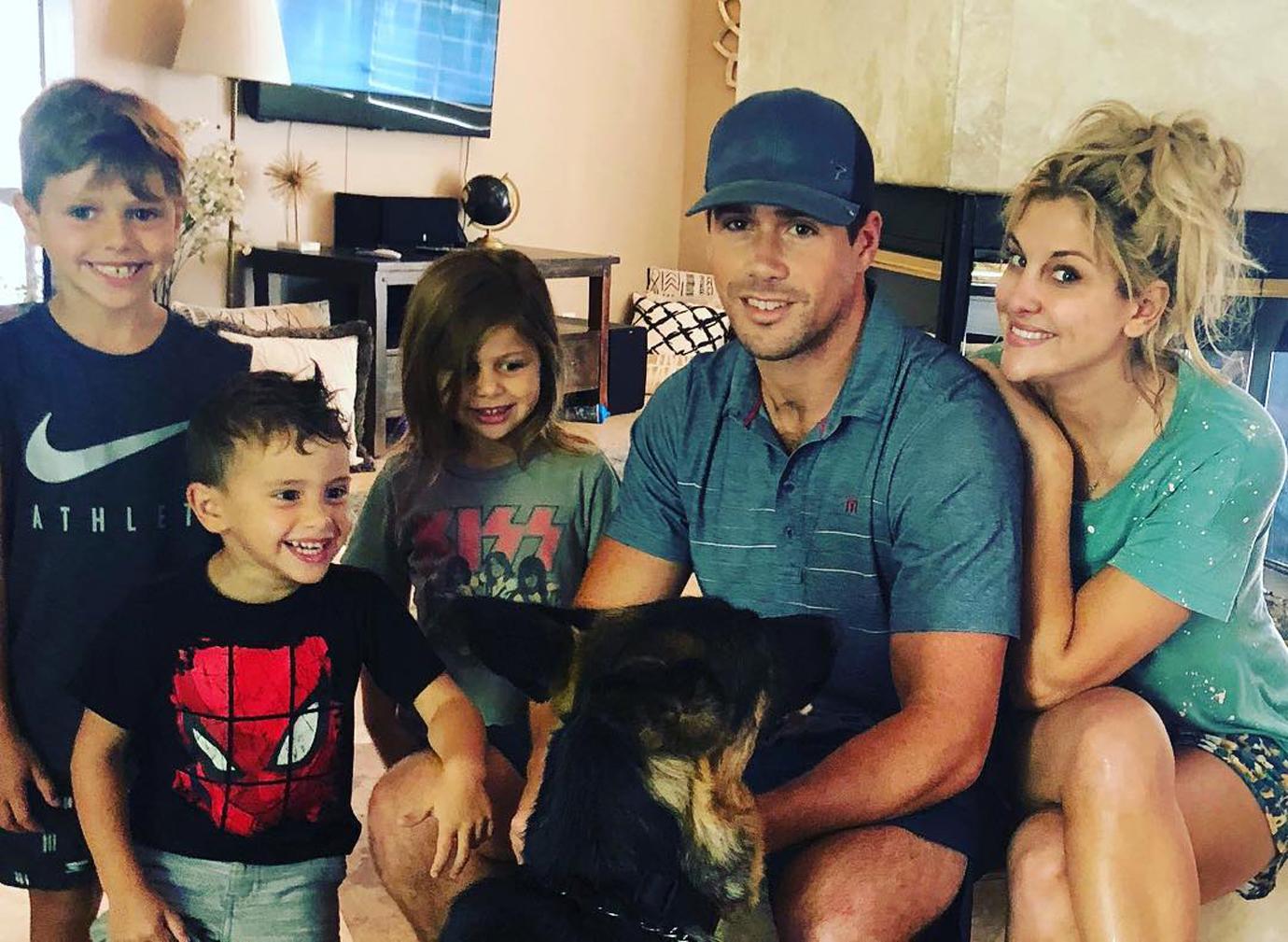 Gina Kirschenheiter and Matt Kirschenheiter Pose Smiling Indoors With Their Children and Dog