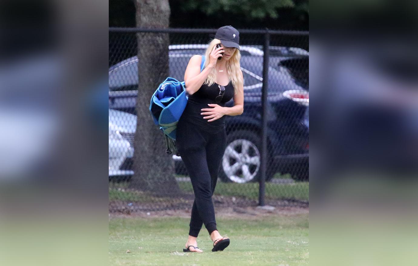 Elin Nordegren Wearing All Black Holding Pregnant Belly And Talking On The Phone at Her Son's Flag Football Game