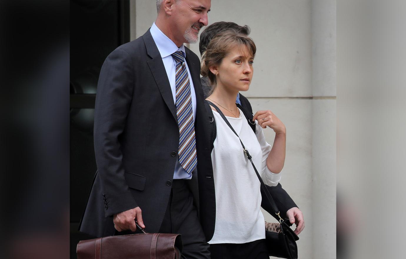 Allison Mack Looks Worried Outside Court Wearing White Top Walking With Lawyers