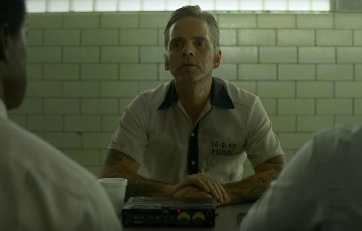 Michael Filipowich sat for interrogation in his beige prison garb in a scene from Netflix’s Mindhunter.