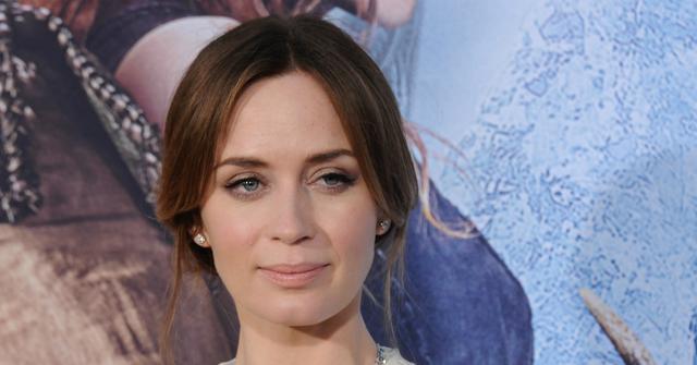 Emily Blunt wears a sleeveless flowing v-neck dress and hair in an updo at The Huntsman Winter's War premiere in 2016.