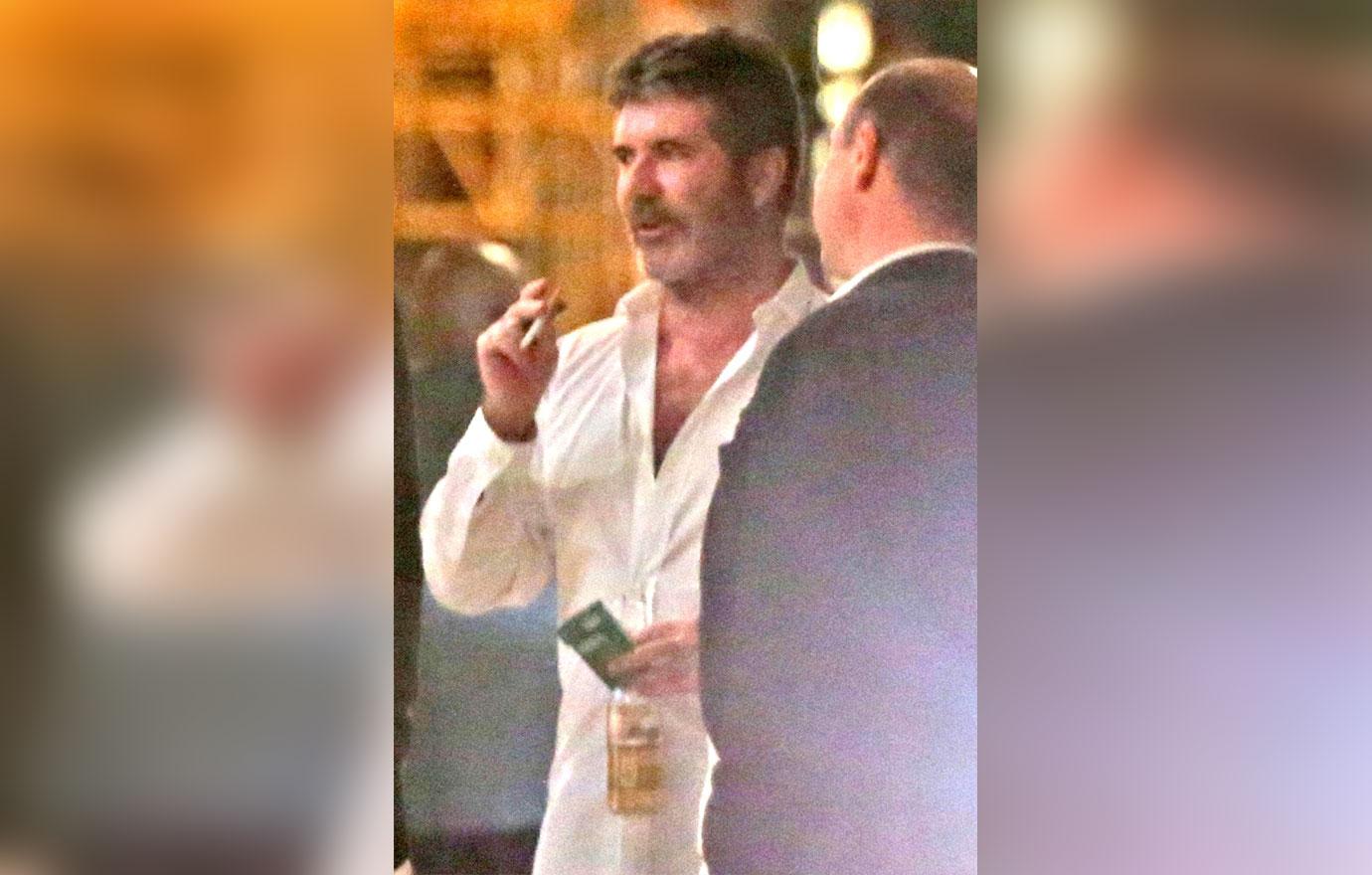 //Simon Cowell drinking after hospital