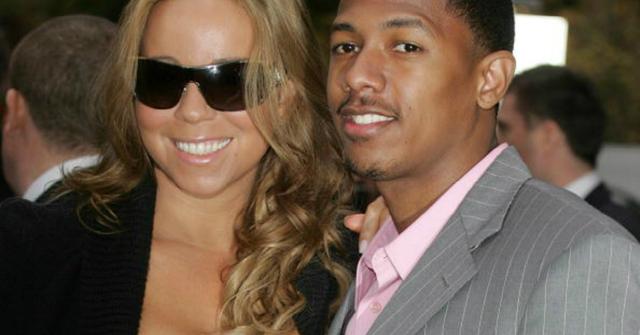 Mariah Carey and Nick Cannon pose for a photo.