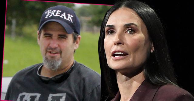 Inset of James Harmon Wearing Dark Baseball Cap And Black T-Shirt, Demi Moore With Mouth Open Wearing Burgandy Blazer