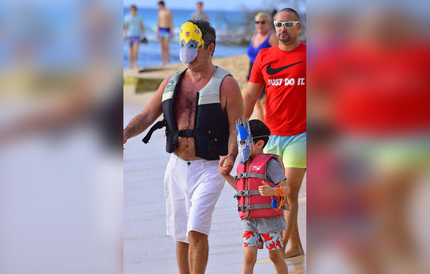 //simon cowell wears transformers mask on jet ski ride with son