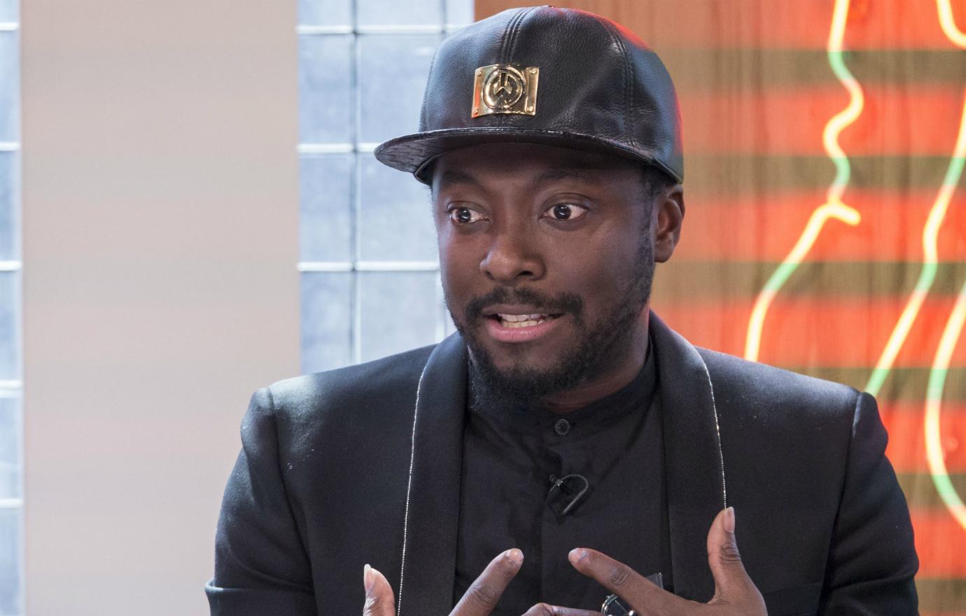 will.i.am made his point on the air in a black blazer and black leather hat.