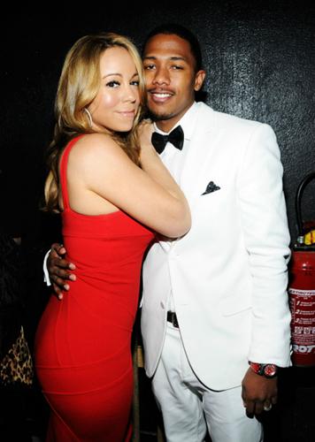 Mariah Carey And Nick Cannon embrace on the red carpet.