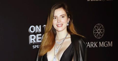 Bella Thorne Poses Smiling Wearing Sexy Deep Low Cut Black Top With Exposed Sides and A Red Heart Print Skirt