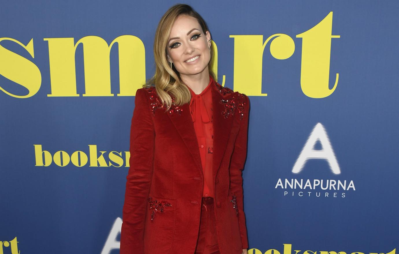 Full frontal nudity veteran Olivia Wilde was all smiles at the Booksmart premiere, sporting a vibrant red pantsuit.