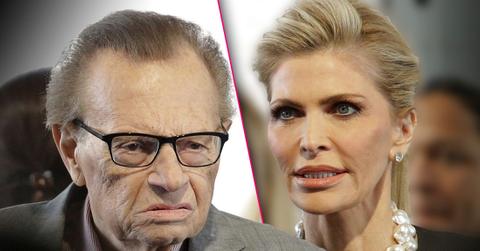 Larry King Wearing Gray Suit looking Angrily at Wife Shawn Equally Angry Wearing Black Suit