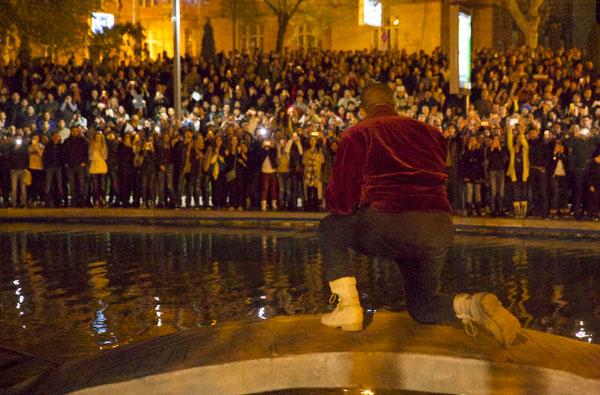 Kanye West jumps into water as fans, cops, jump in along with the soaking wet rapper at last minute concert in Armenia. Kanye decided to organize the show at literally 9pm on late Sunday night and by using social media over 3,000 screaming fans showed up at the duck pond to watch him perform at nearly 1:20am local time. Kanye was on stage singing his hit when his mic started to short out as the crowd noticed. Minutes later he asked a section of the crowd if they could see him and after realizing they could not, he jumped literally into the middle of the duck pond and drops his mic into the water due to it being too wet and ruined. He is then literally surrounded by the fans as they run into the water with him as his bodyguard Pascal is spotted running to his side along with the Armenian National Guard and Police all getting soaking wet to retrieve the rap star. Kanye was then brought closer as a fan tried to touch his hand, the cops pushed him and Kanye reacted to holding the cops back to let the fan get a photo with him in the pond too! Madness occurs in a stampede style follow as Kanye is finally pulled to the top of the pond and is guided with his entourage out of the park with thousands running and following him out of the concert. Kim Kardashian was shown on side stage watching her man perform and was all smiles