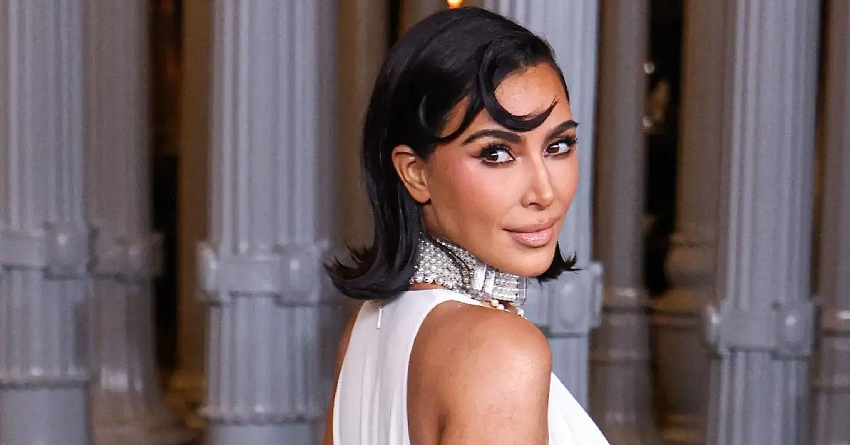 kim kardashian wearing princess diana cross necklace vulgar cleavage