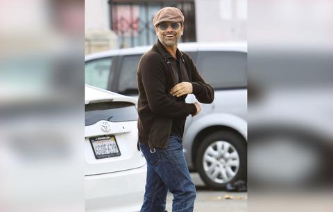 John Stamos Wearing Light Brown Cap, Sunglasses, Dark Brown Sweater and Jeans