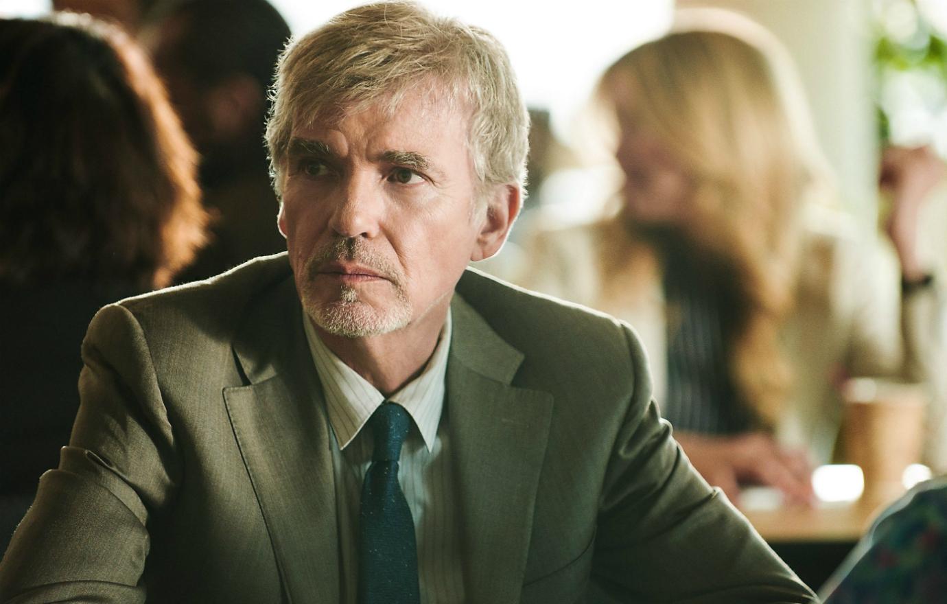 Billy Bob Thornton wore a dark suit with a blue tie in Goliath.