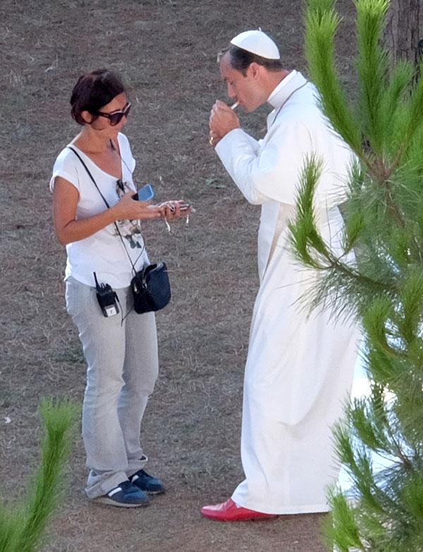 //jude law smokes cigarette dressed up as pope