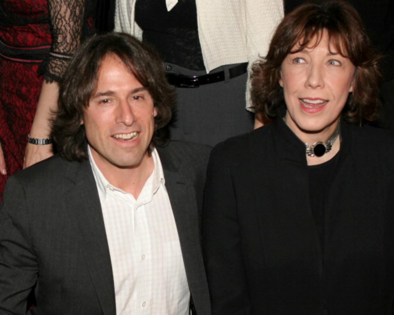 Lily Tomlin and David O. Russell look into the distance.