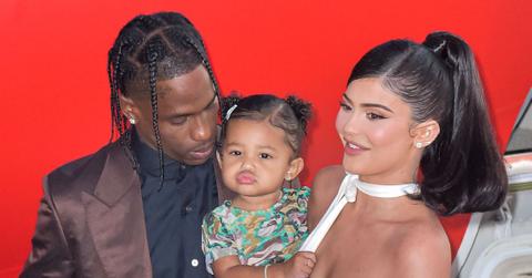 Travis Scott Wearing Brown Suit, Stormi Wearing Multicolored shirt and pants,, Kylie Jenner Wearing White D&G Midi Dress