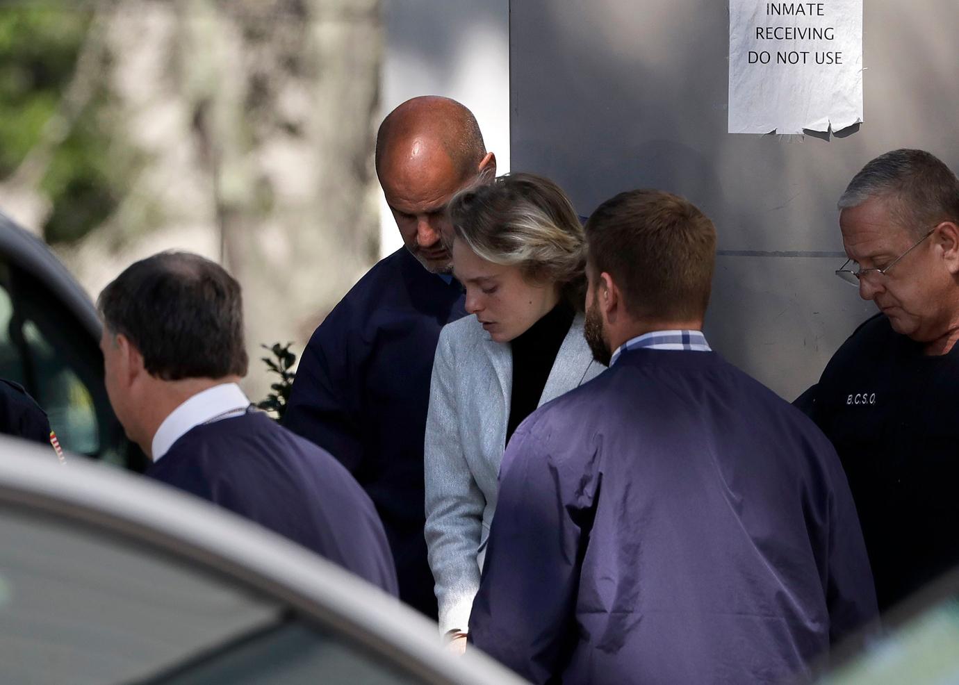 Michelle Carter, center, departs following a parole hearing on in Natick, Mass. Carter has served seven months of a 15-month jail term for urging her suicidal boyfriend Conrad Roy III.