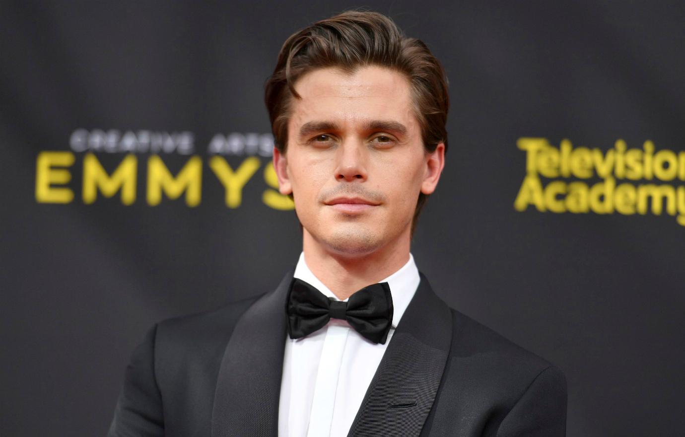 Antoni Porowski wears a black tux and white shirt while on the red carpet.