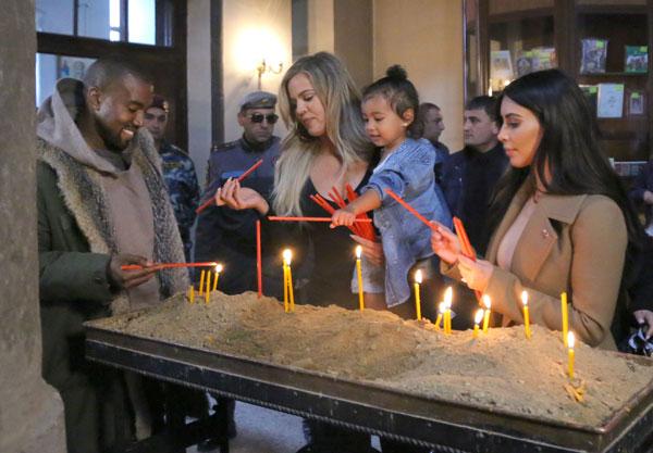 Kim & Khloe Kardashian Light A Candle In Armenia With North West