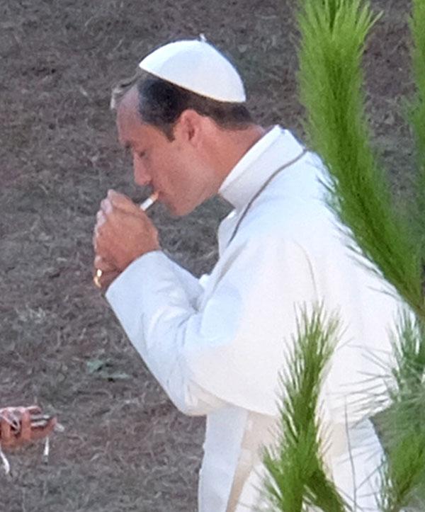 //jude law smokes cigarette dressed up as pope