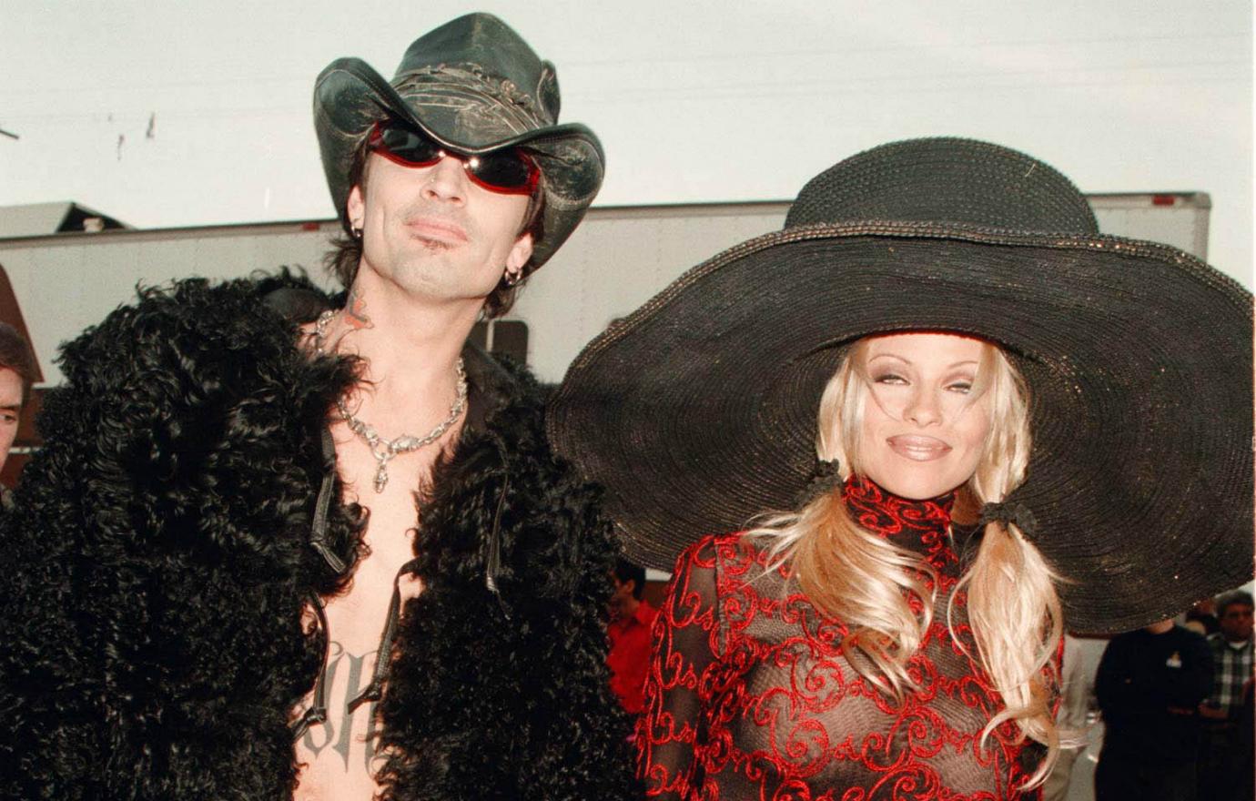 Tommy Lee and Pamela Anderson seen in happier times and with enormous hats. The pair arrived at the American Music Awards with both trying to outdo the other in the outrageous fashion department — she in a red see-through knitted dress and he in leather pants and a furry jacket.