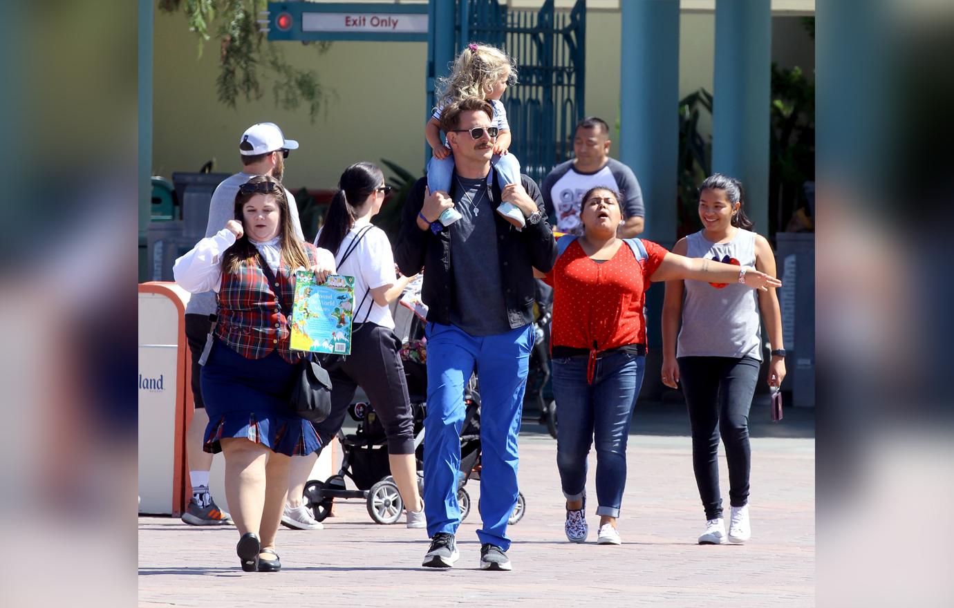 Bradley Cooper enjoys a day at Disneyland with his daughter Lea.