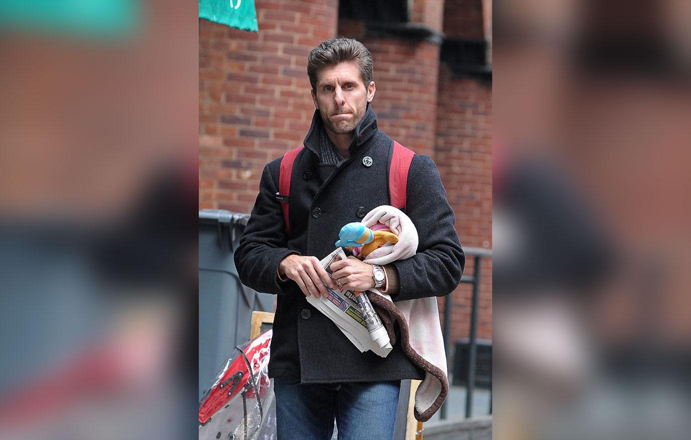 Jason Hoppy wears a black winter jacket and a bookbag.