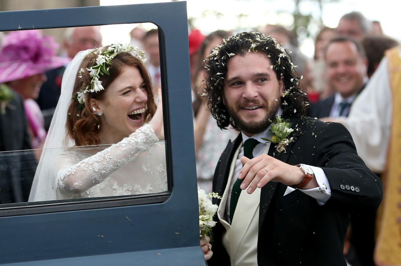 Kit Harington and Rose Leslie smile on their wedding day with their Land Rover Defender getaway car