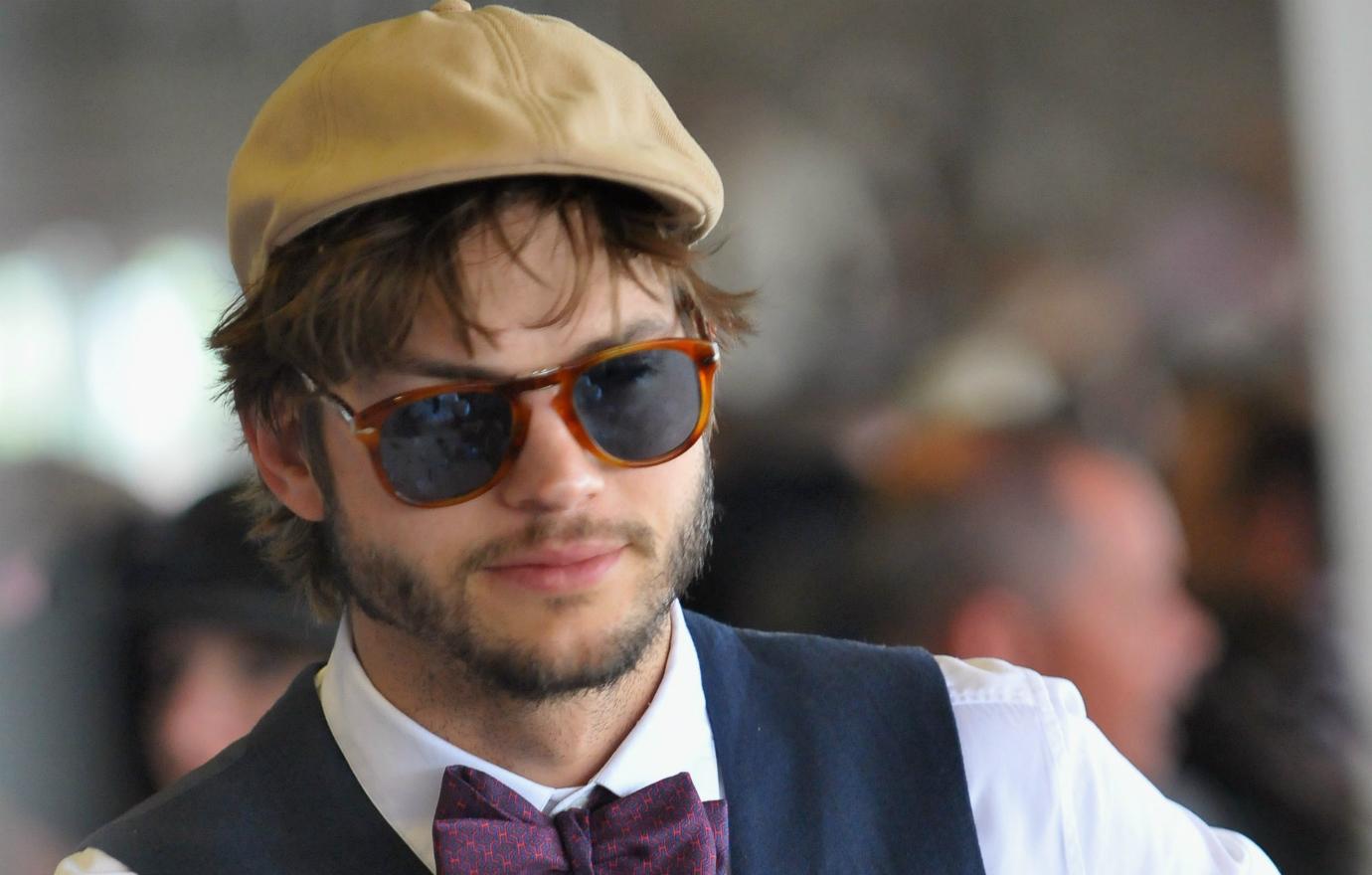 Ashton Kutcher wore a bow tie with a grey vest as he attended the Kentucky Derby.