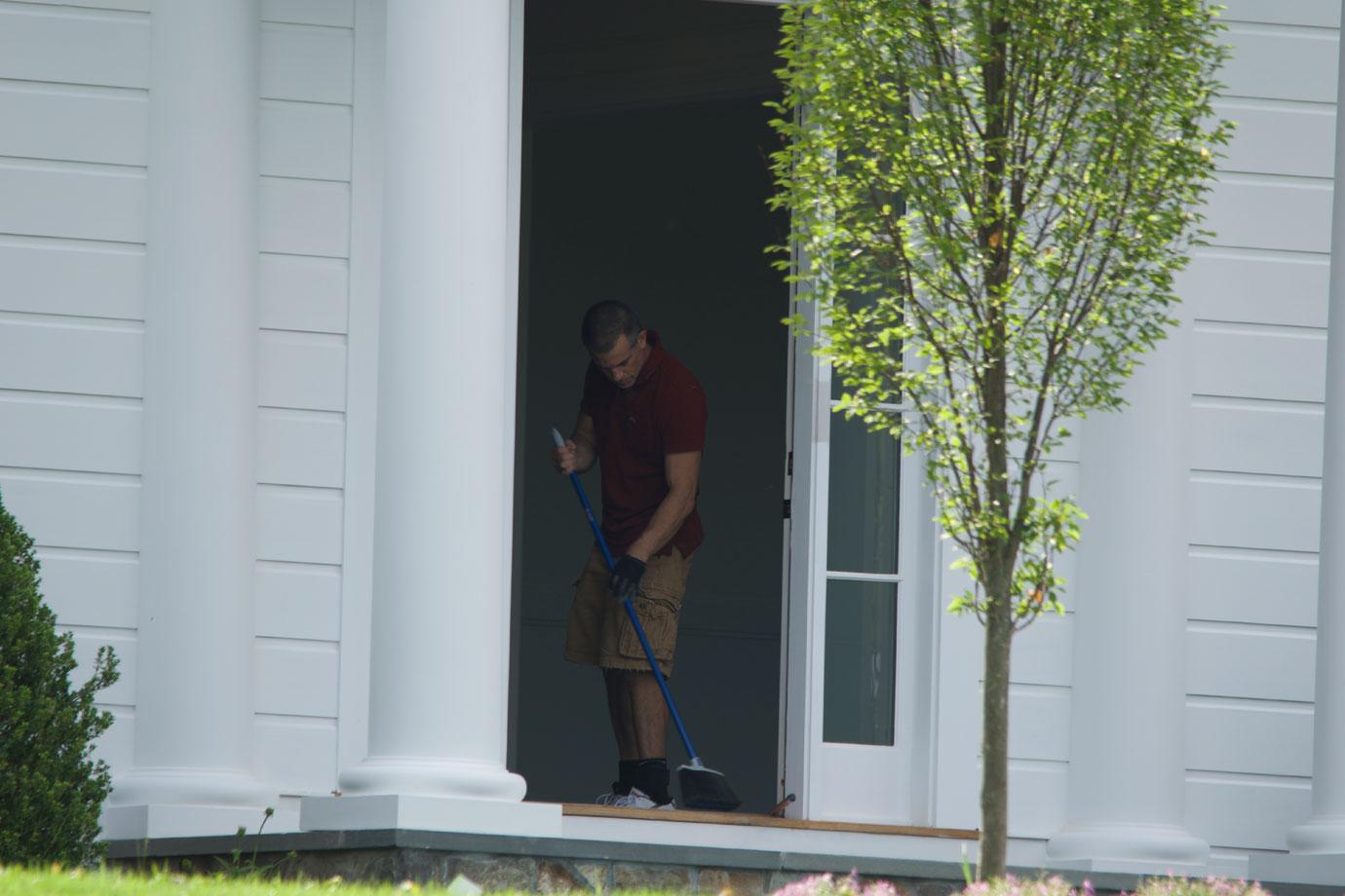 Fotis Dulos standing in front of the house