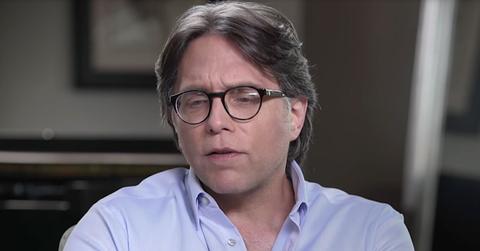 Keith Raniere of NXIVM in Glasses and Blue-Purple Shirt Eyes Looking Down