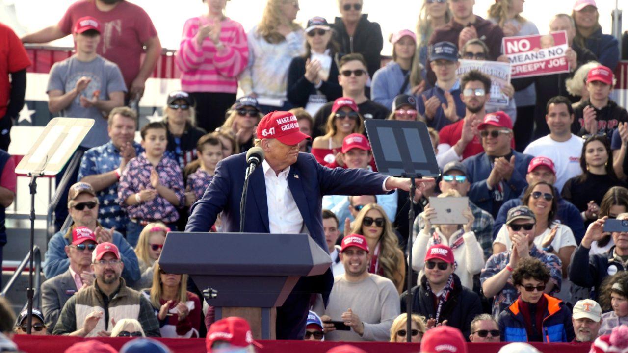 The president covered his hair with a hat during a particularly windy day.