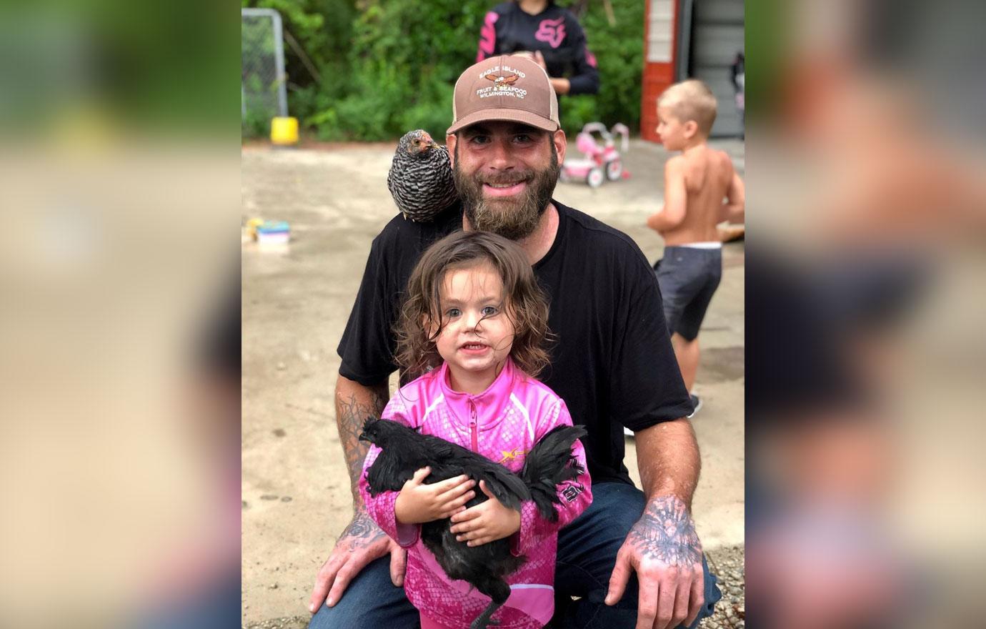 David Eason holds one of his children.