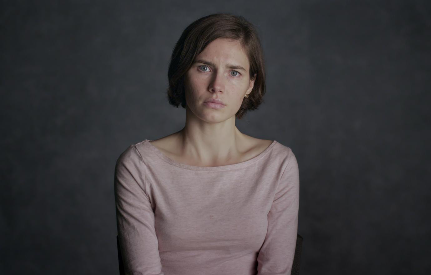 Amanda Knox wore a pink sweater in a promotional still from the Netflix true crime documentary, Amanda Knox.