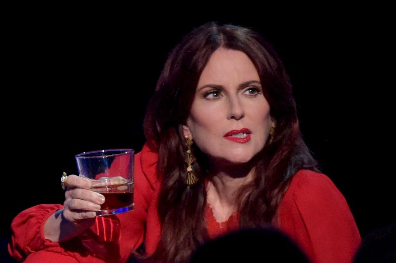 Megan Mullally Wearing Red Dress and Whiskey in Her Hand