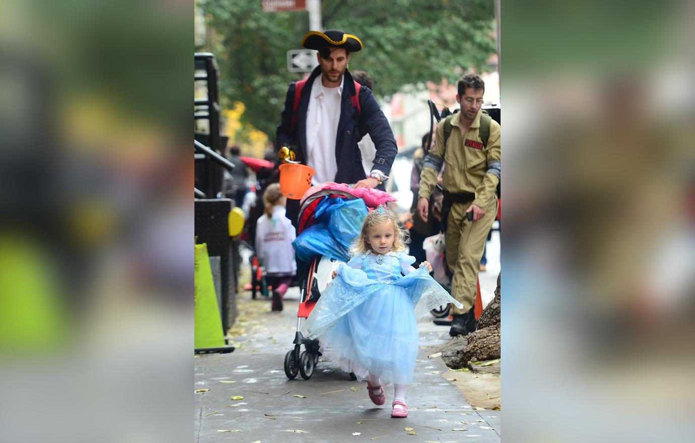 Jason Hoppy wears a costume with his kid.