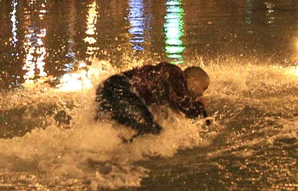 Kanye West jumps into water as fans, cops, jump in along with the soaking wet rapper at last minute concert in Armenia. Kanye decided to organize the show at literally 9pm on late Sunday night and by using social media over 3,000 screaming fans showed up at the duck pond to watch him perform at nearly 1:20am local time. Kanye was on stage singing his hit when his mic started to short out as the crowd noticed. Minutes later he asked a section of the crowd if they could see him and after realizing they could not, he jumped literally into the middle of the duck pond and drops his mic into the water due to it being too wet and ruined. He is then literally surrounded by the fans as they run into the water with him as his bodyguard Pascal is spotted running to his side along with the Armenian National Guard and Police all getting soaking wet to retrieve the rap star. Kanye was then brought closer as a fan tried to touch his hand, the cops pushed him and Kanye reacted to holding the cops back to let the fan get a photo with him in the pond too! Madness occurs in a stampede style follow as Kanye is finally pulled to the top of the pond and is guided with his entourage out of the park with thousands running and following him out of the concert. Kim Kardashian was shown on side stage watching her man perform and was all smiles