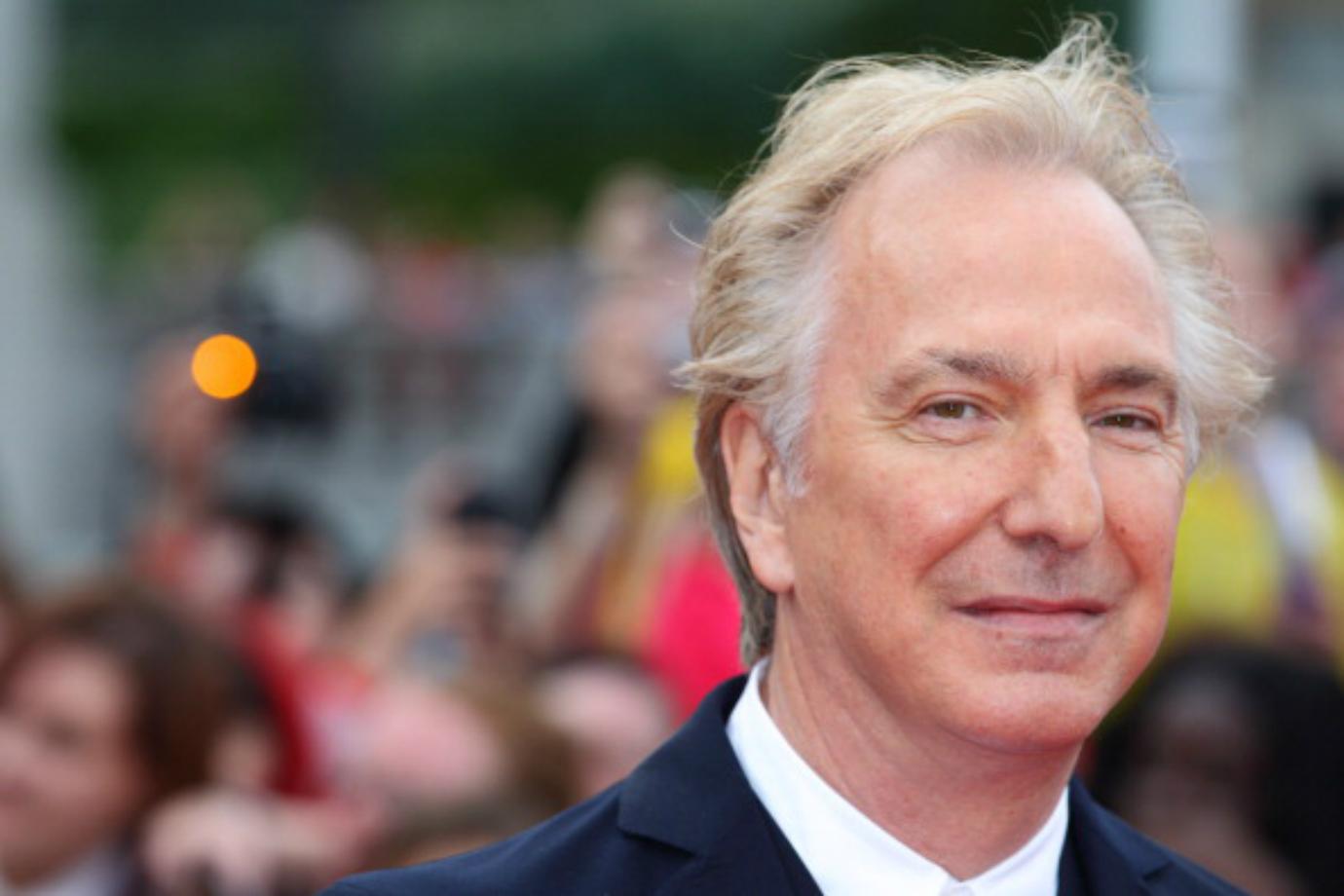 Alan Rickman smiles on the red carpet.