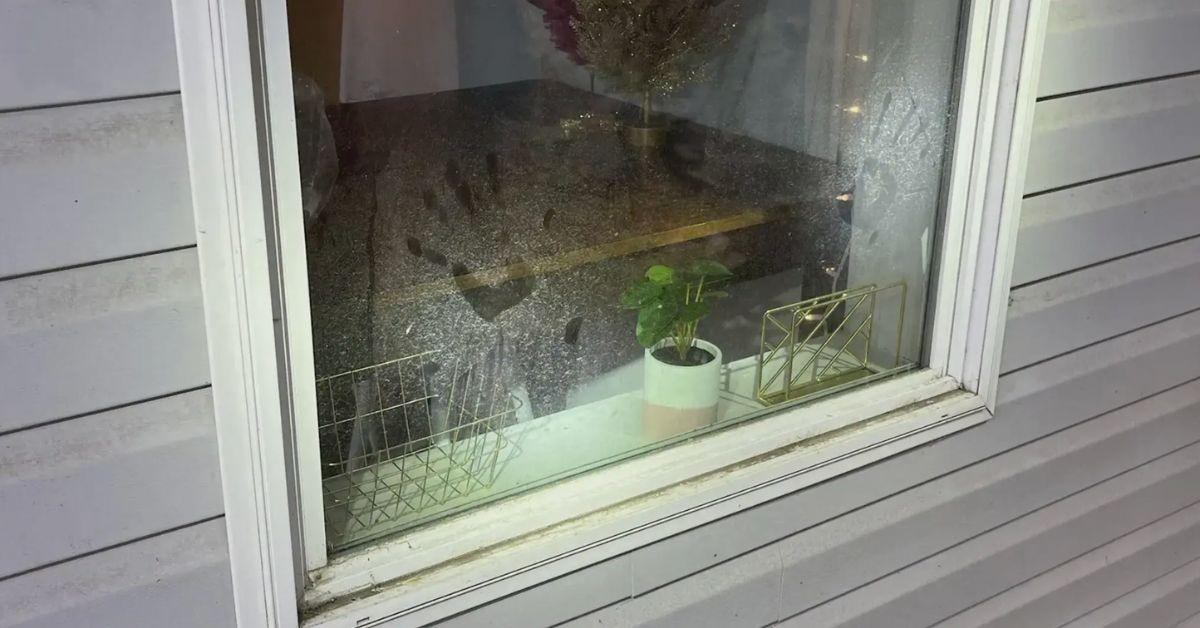 A handprint was left behind on a dirty window.